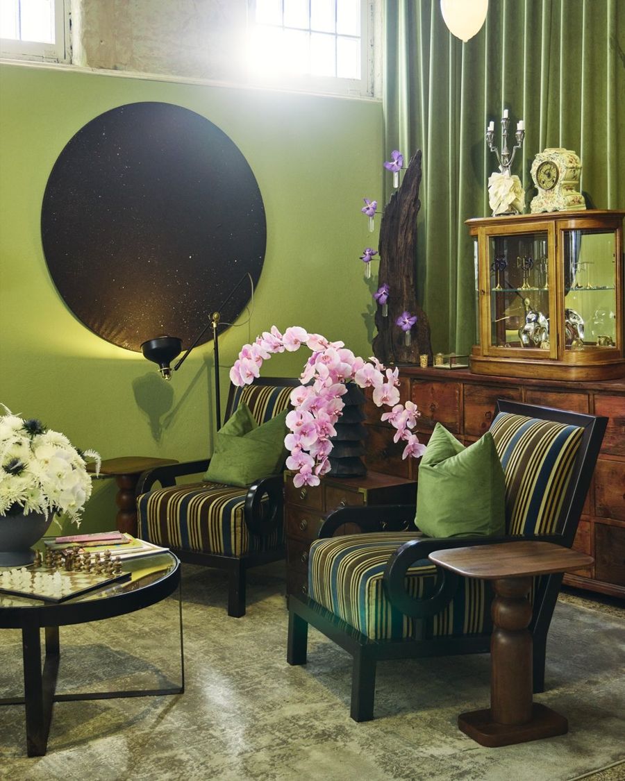 The gallery: sage walls, striped velvet chairs and pink orchids